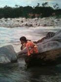 The little girl is worshiping Ganga river.